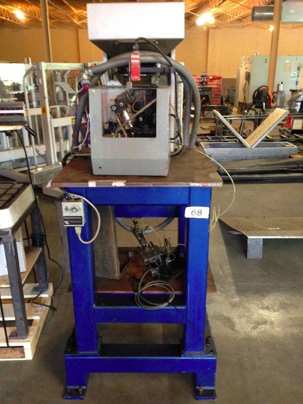Heavy duty stand with screw feeder machine on top.