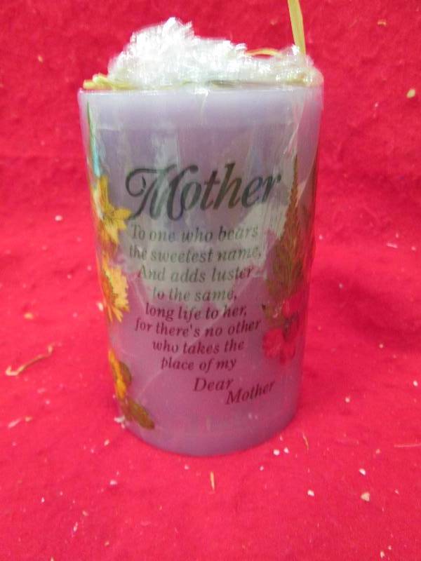 Purple candle that says Mother To o...