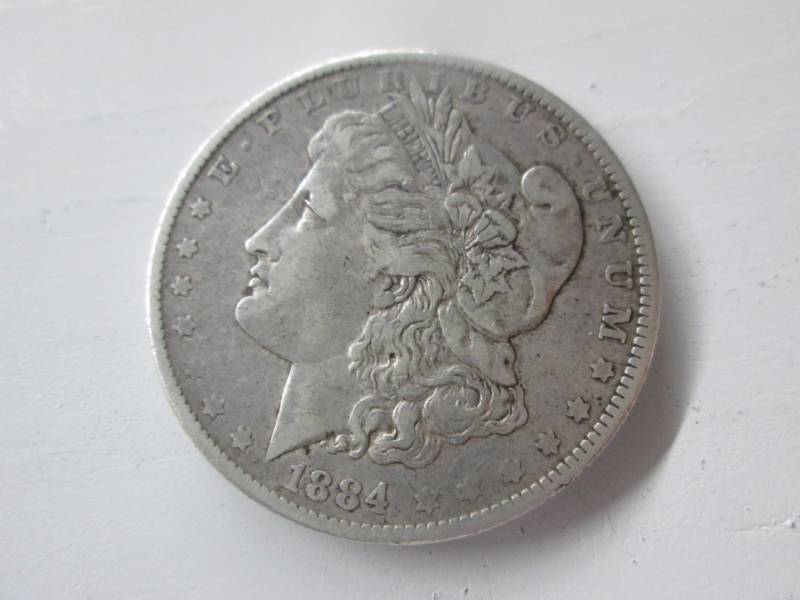 lot 21 image: 1884 O Morgan Silver Dollar