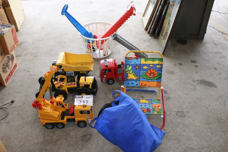 lot 237 image: Toy Lot Including Toy Trucks Toy Digger Toy Pogo Stick And More.