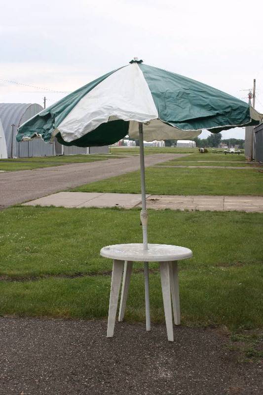 lot 271 image: Lot of (2) Circular Tables wUmbrella Table 36 Diameter Umbrella 60 Diameter.