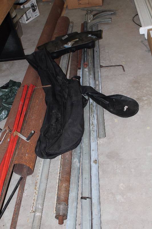 lot 89 image: Floor Lot Including Metal Bars Garage Door Tracks And More.