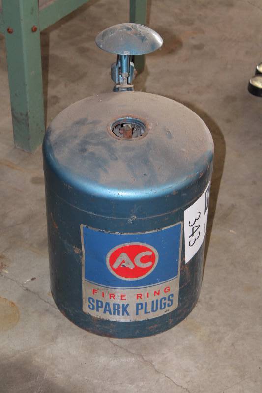 lot 343 image: AC Fire Ring Spark Plug Cleaner Canister.