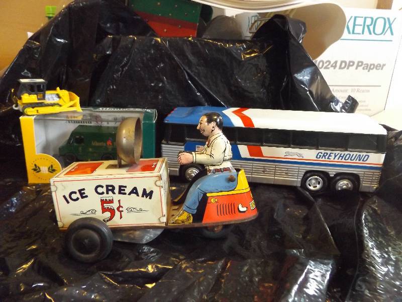 Toys, some vintage. Olympic truck bank, promotion bull dozer, greyhound bus, wind up icecream bike, missing one wheel