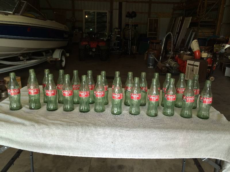 lot 85 image: Twenty Five 8oz Coca Cola Classic Bottles