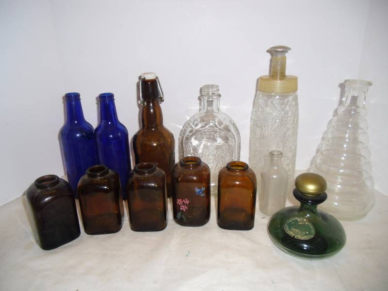 lot 39 image: Glass Bottle Collectors Skyy Cobalt Blue, Brown Spice Jars, Green Avon bottle, Log Cabin 