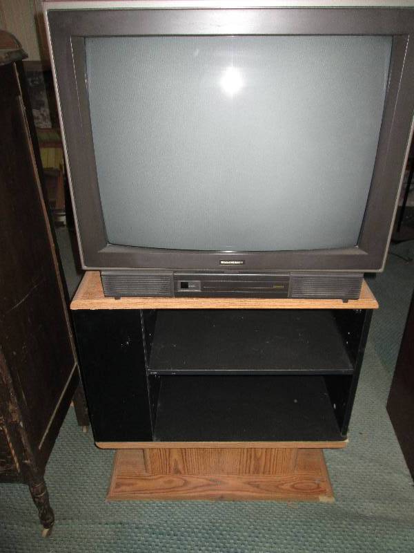 lot 9 image: TV on a nice entertainment stand wi...