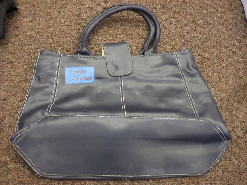 lot 144 image: New Estee Lauder Purse...