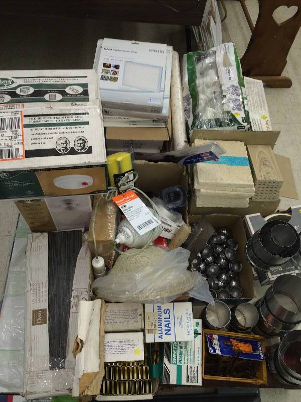 lot 102 image: pallet of tile,fence post caps, door knobs, plumbing , filters staple gun staples ,lights,lamp ,misc
