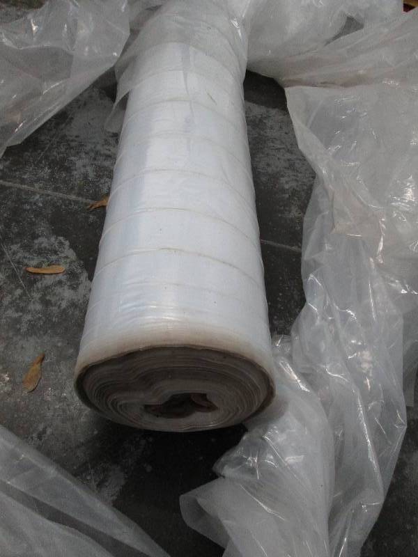 lot 63 image: LARGE roll of plastic sheeting, gre...