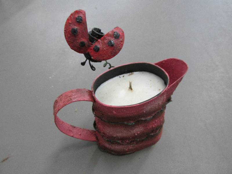 lot 195 image: New candle in watering can with a b...