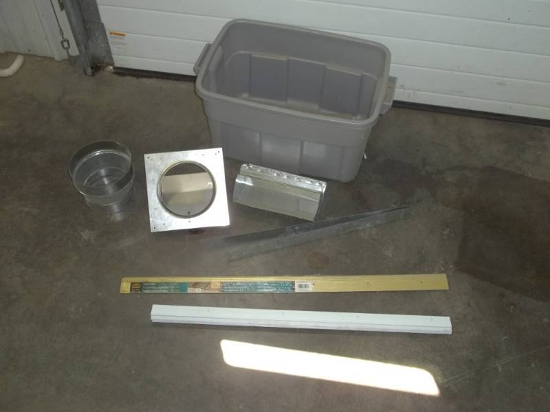 lot 76 image: Assorted parts, Storm door slide, carpet edge, dryer vent and other parts with tub