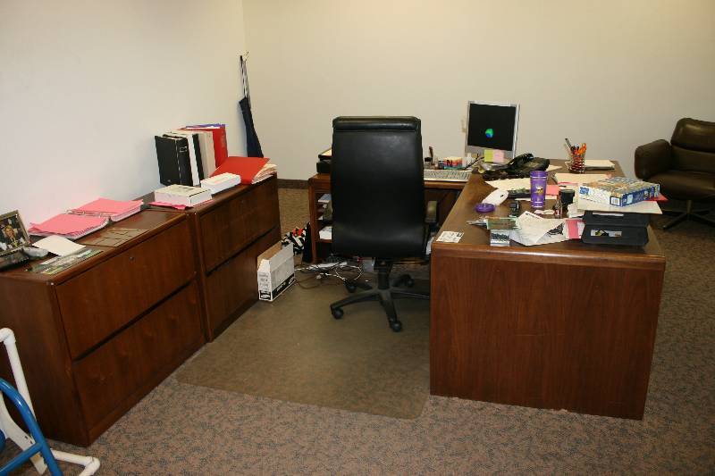 lot 1086 image: Lot of (4) Including Wood-Style Office Desk wDrawers, L-Shaped, 77 x 71 x 20 x 35 Wood Style Cabinets wTwo Drawers, 20 x 37 x 29.5 Leather-Style Office Chair wArm Rests & Wheels Does Not Include Contents.