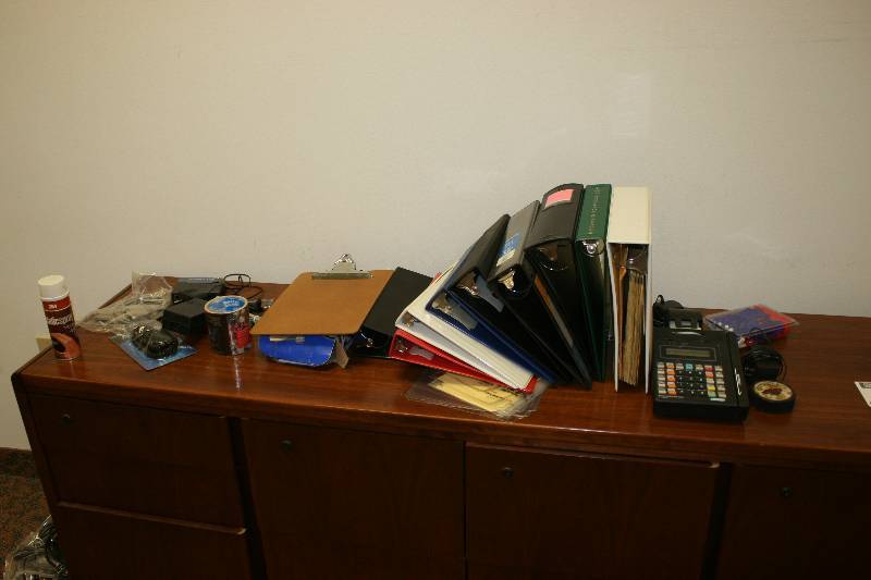 lot 1087 image: Contents of Cabinet Including Credit Card Machine Pumie Scouring Stick Plastic Binders And More.