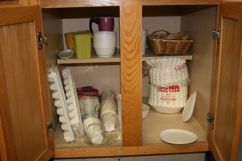 lot 1061 image: Kitchen Cabinet Lot Including Ice Cube Trays Coffee Filters Hot Pad And More Does Not Include Actual C abinets.