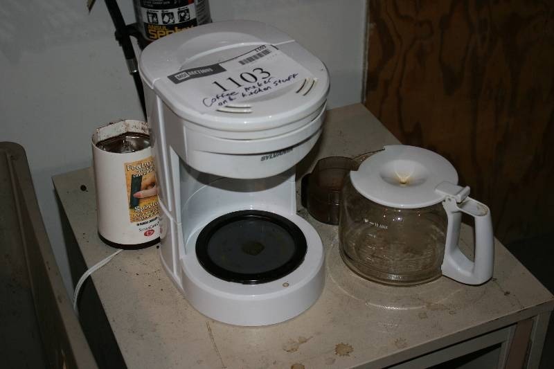 lot 1103 image: Contents of Cabinet Including Coffee Maker wPot Coffee Grinder Coffee Pot And More.