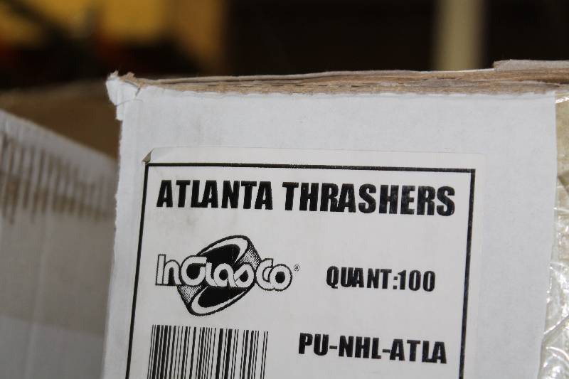lot 807 image: Box of Atlanta Thrashers Hockey Pucks wLogo.