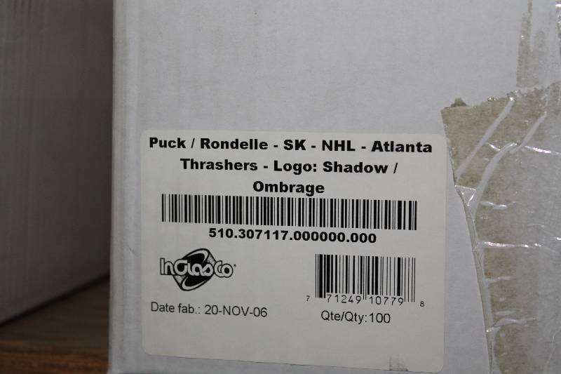 lot 808 image: Box of Atlanta Thrashers Hockey Pucks wLogo.