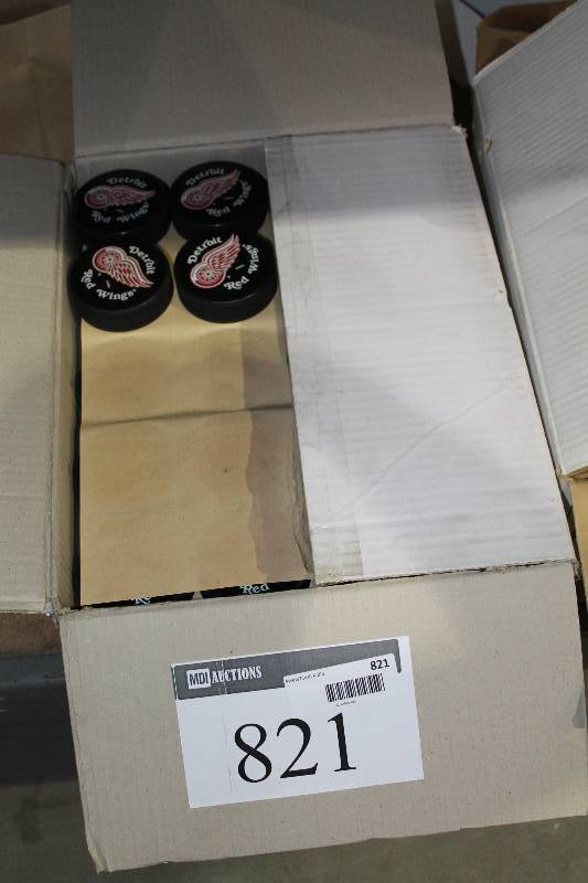 lot 821 image: Box Lot of Hockey Pucks wDetroit Red Wings Logo.