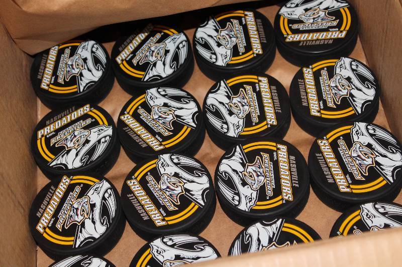 lot 822 image: Box Lot of Hockey Pucks wNashville Predators Logo.