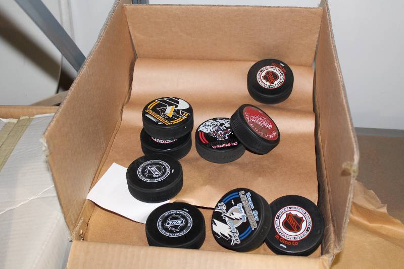lot 819 image: Box Lot of Hockey Pucks wMiscellaneous NHL Team Logos.