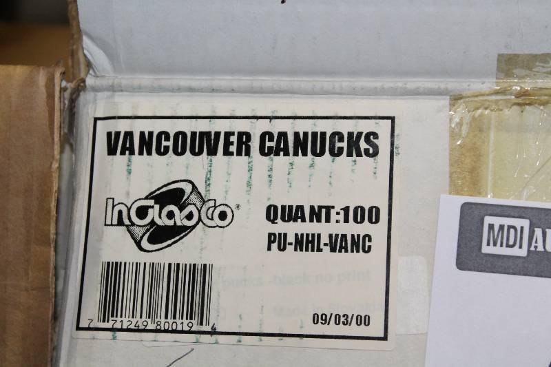 lot 815 image: Box Lot of Hockey Pucks wVancouver Canucks Logo.