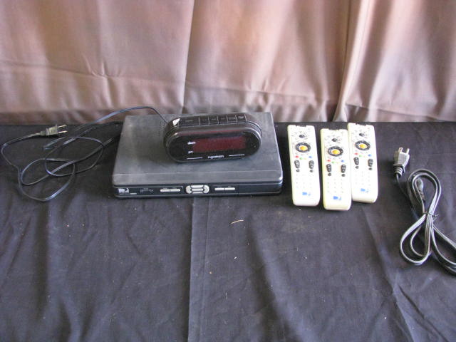 direct tv box and three remotes