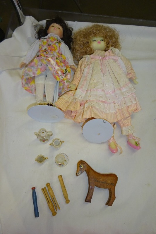 lot 88 image: 2 Ceramic Dolls with stands Tea set (Glass) Wooden horse