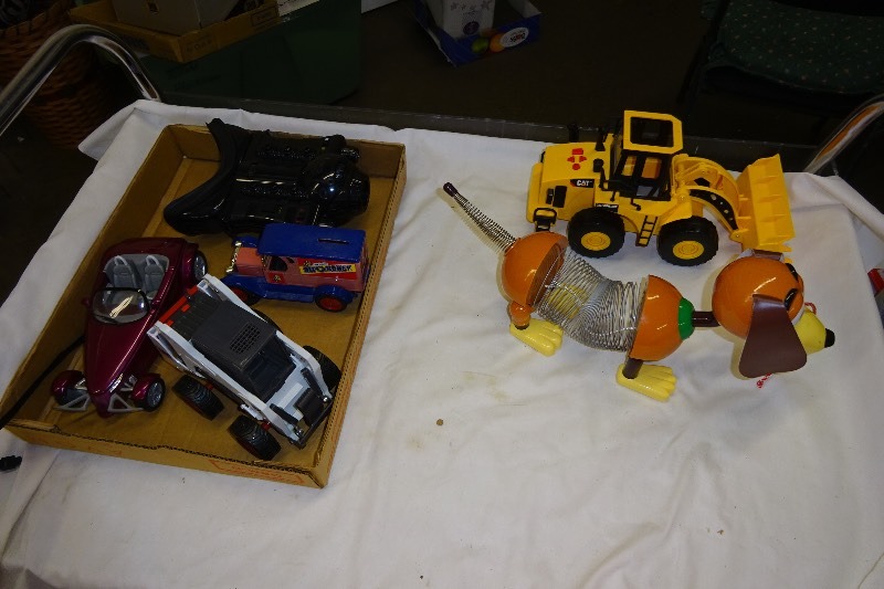 lot 118 image: Slinky dog, cat, truck and tractor, bobcat plastic, bit o honey, metal car bank