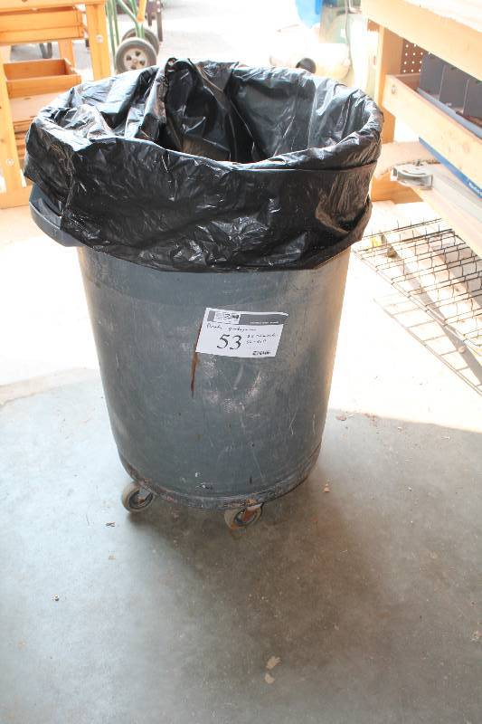 lot 53 image: Brute Plastic Garbage Can wWheel Base 22 Diameter, 32 Height.