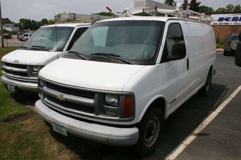 lot 1 image: Chevrolet Express 3500 License Plate YBB8665 VIN 1GCHG35R321181485 Type Truck Includes Utility Racks & Rear Storage wMultiple Shelving Units & Storage Units.