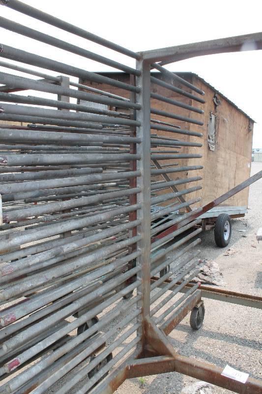 lot 107 image: Large Metal Racking Units wWheels Pole Shelves On Both Sides For SidingTubing Storage 94 x 80 x 90.