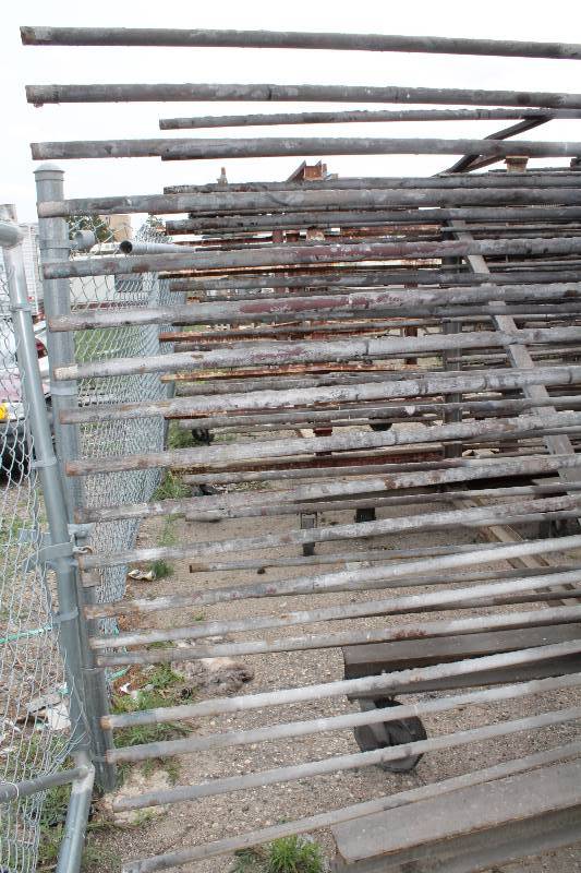 lot 125 image: Large Metal Racking Units wWheels Pole Shelves On Both Sides For SidingTubing Storage 94 x 80 x 90.