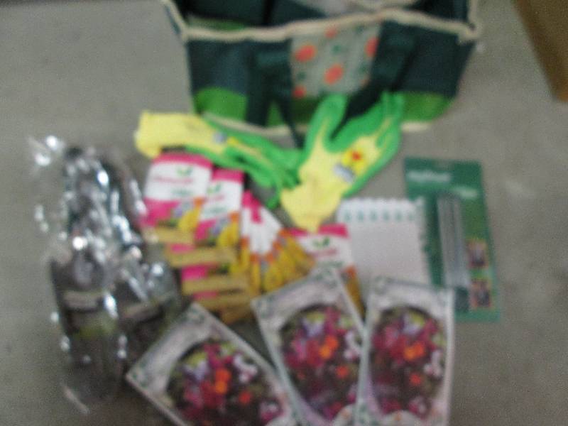 tote with seeds gloves 2 shovels pl...