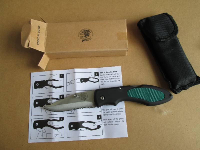 one black and green pocket knife...