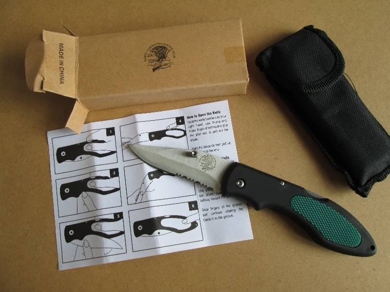 one black and green pocket knife...