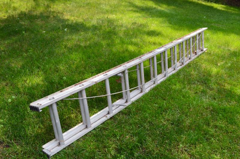 lot 19 image: Lot of (2) Aluminum Extension Ladder 12 Foot Section Extends To 20 Feet Operational.