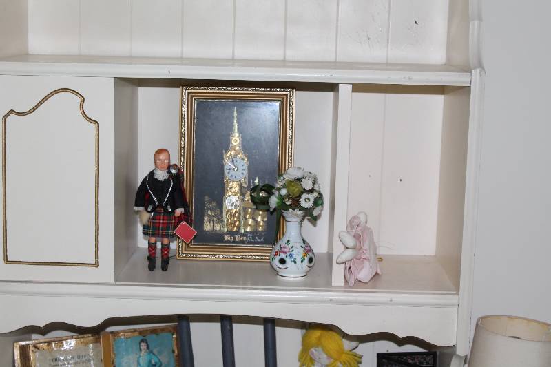 lot 13 image: Contents of Desk & Dresser Including Decorative Flowers Ornamental Clock Dolls And More.
