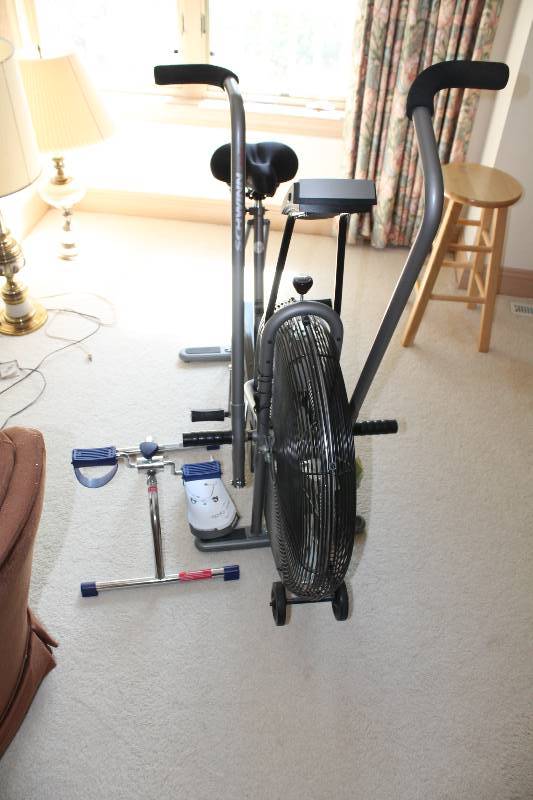 lot 22 image: Lot of (2) Including Schwinn Airdyne Exercise Bicyle, Stationary wDigital Display Life Care Mini Cycle Foot Pedal Exercise Bar, Model 91381.
