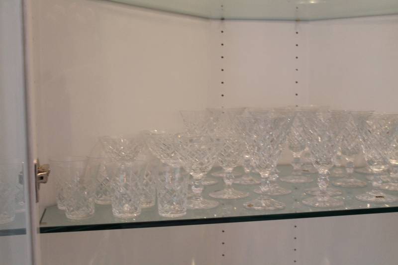 lot 97 image: Shelf Lot Of Crystal Ware Including Small Glass Cups Shot Glasses Tall Glasses And More.