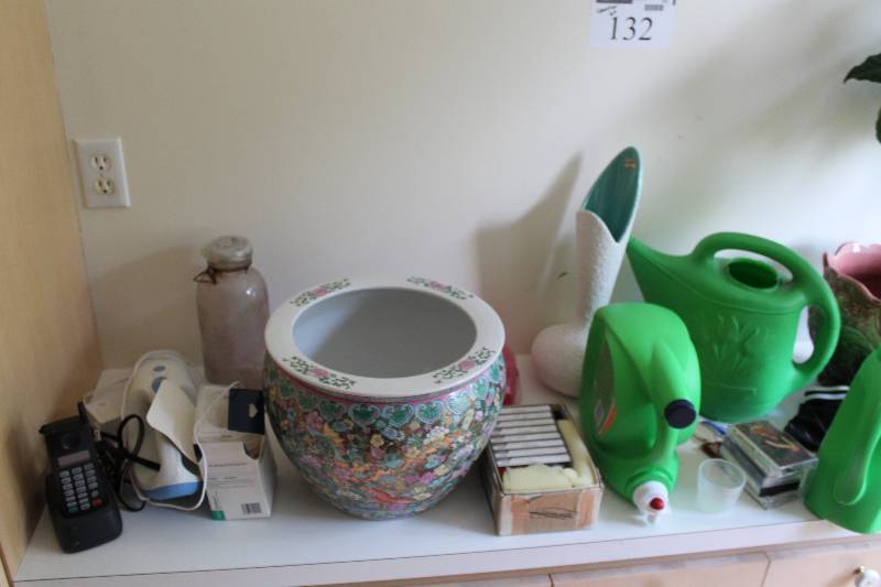 lot 132 image: Counter Lot Including Decorative Pot wPlant Decorative Pots Plastic Watering Cans And More.