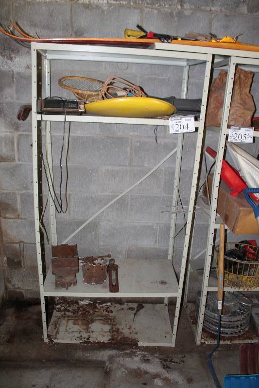 lot 205 image: Contents of Both Shelving Units Including 81 Cadillac Hub Caps 60s Z28 Hub Caps Ski Poles And More.