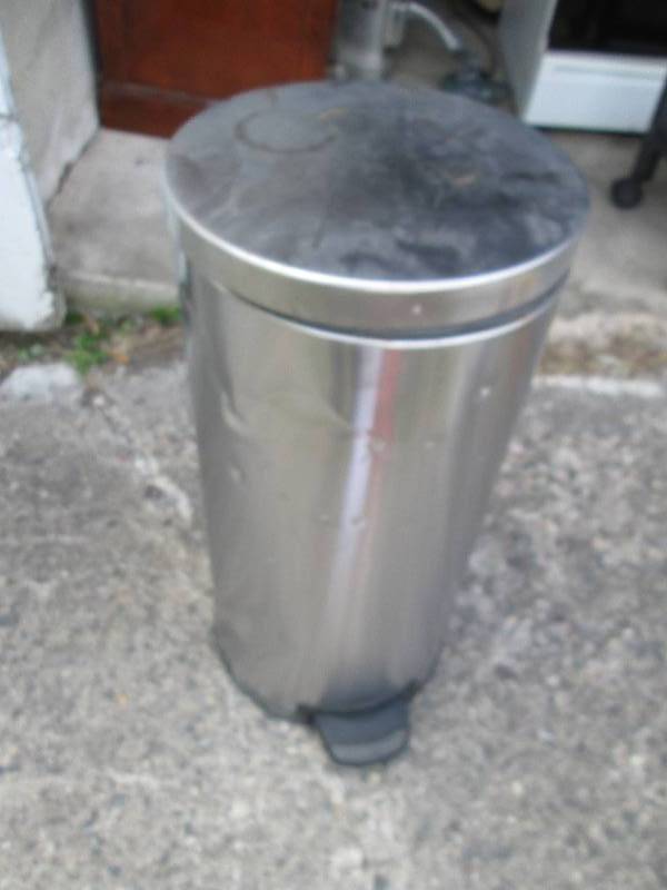 Metal trash can, has some dents...
