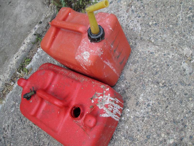 2 5 gallon gas cans, one has no spo...