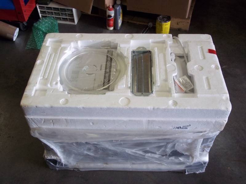 lot 55 image: New in crate Whirlpool under cabinet microwave with exhaust
