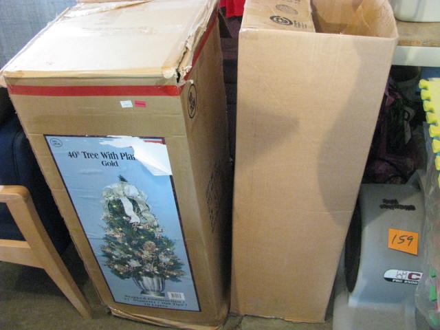 two boxed smaller christmas tree items