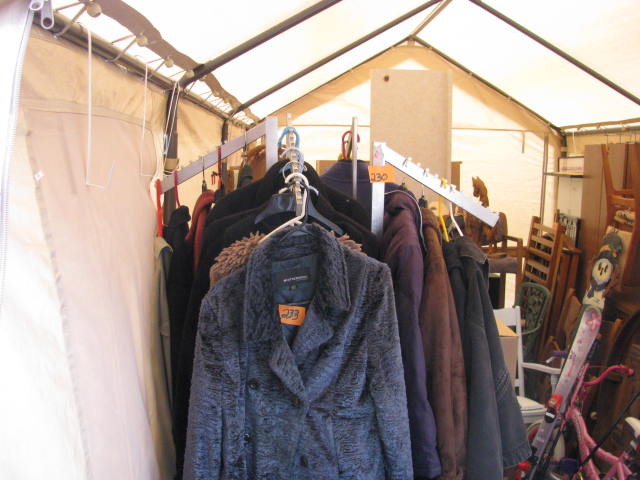 large clothing rack on wheels with 4 arms for display