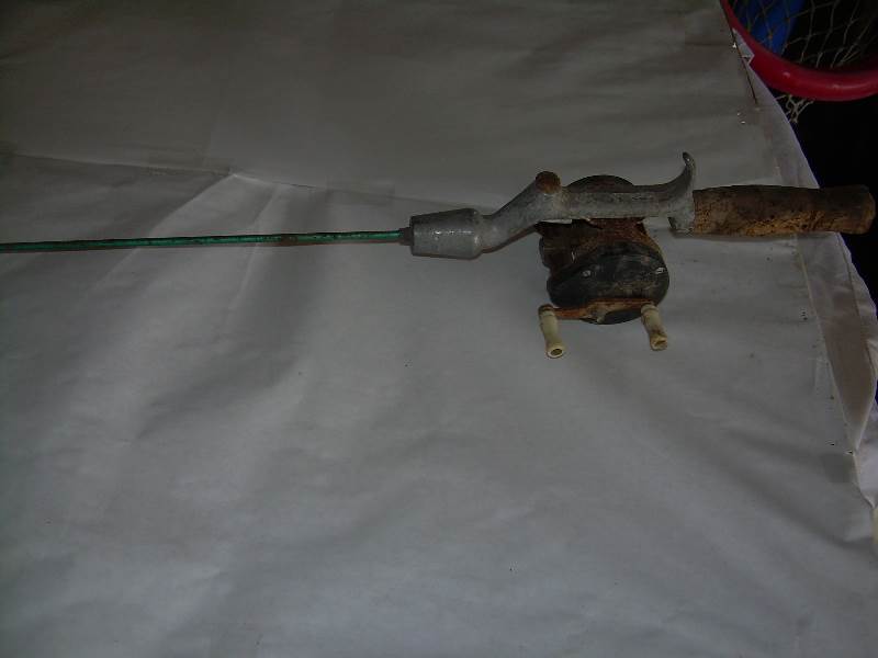 Antique steel fishing rod and reel.