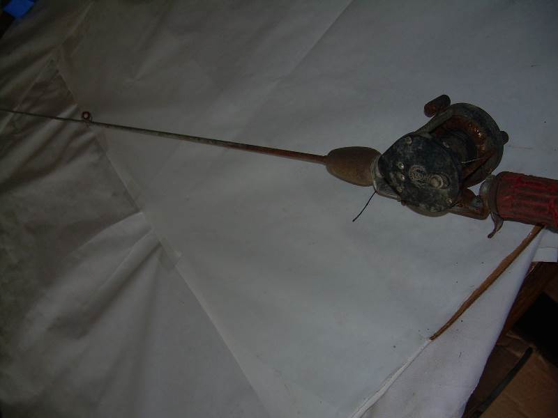Antique steel fishing rod and reel.