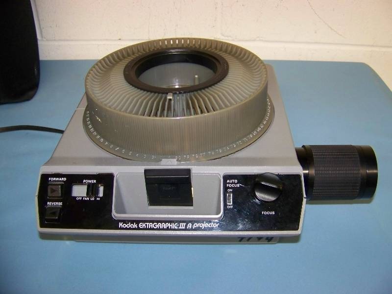 lot 101 image: Kodak, Slide Projector with Slide Carousel  Tray, Remote Control and Travel Case